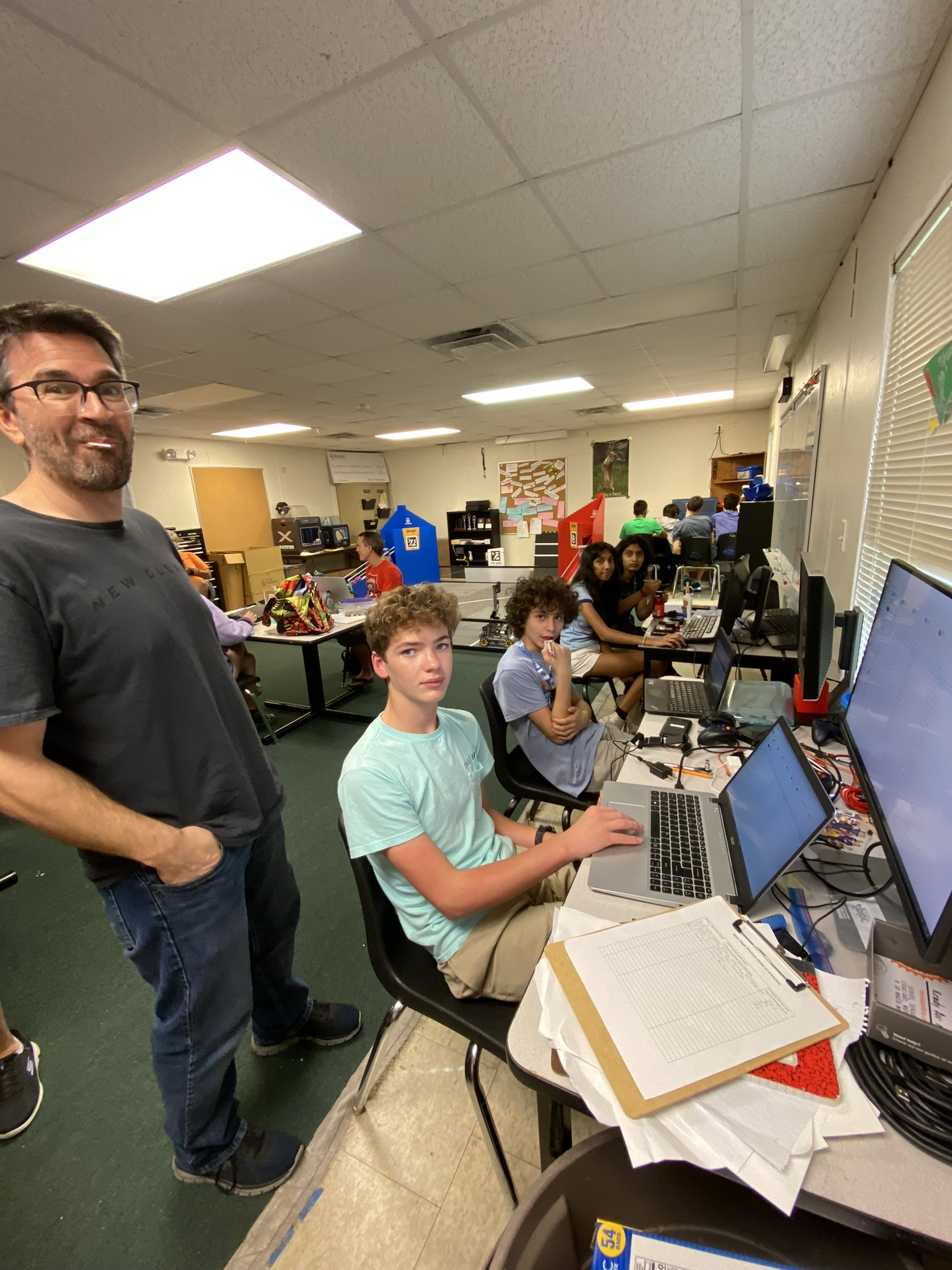 Students testing a mechanism on bench